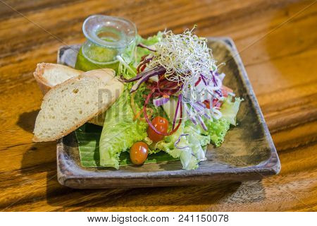 Bread, Green Vagatable And Tomato Salad In Plade On Wooden .