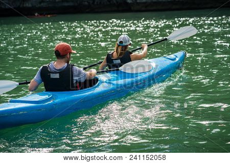 Tourists Paddling Kayak On Halong Bay In Vietnam, Unesco World Heritage Site