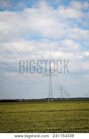 Power Line And Wind Turbines In The Countryside