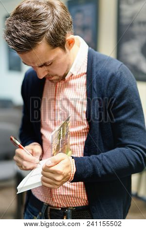 Vilnius, Lithuania - May 4, 2016: Belorussian Novelist And Journalist Sasha Filipenko Autographing H