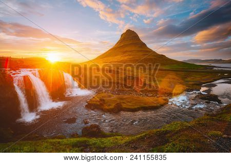 Majestic sunset with Kirkjufellsfoss waterfall. Location Iceland, Europe. Scenic image of most popular tourist attraction. Travel destination of photographed place. Discover the beauty of earth.