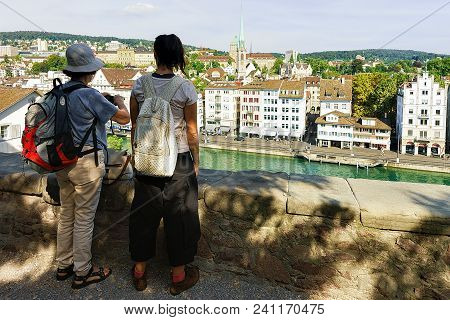 Zurich, Switzerland - September 2, 2016: Two Female Tourists Backpackers Looking At Limmatquai, Zuri