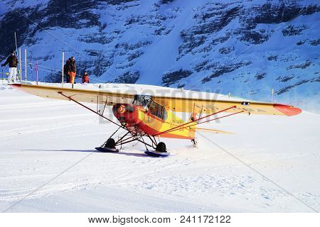 Maennlichen, Switzerland - December 31, 2013: Airplane In Swiss Alpine Mountain Maennlichen, In Wint