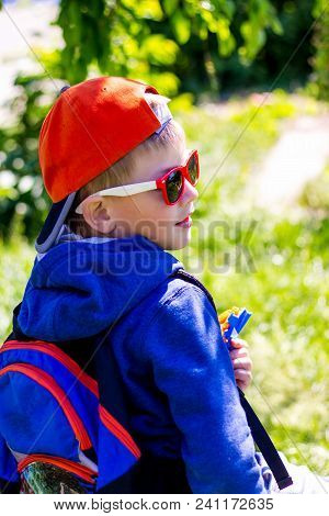 Ukraine. Khmelnytskyi. May 2018. Fashionable Dressed Boy With  Backpack Behind His Shoulder While Tr