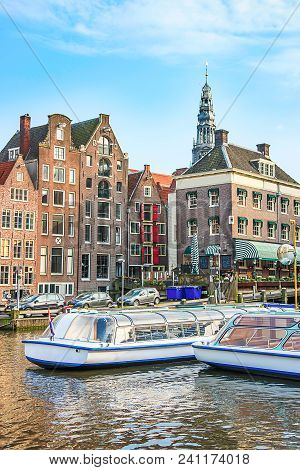 Damrak Canal, Boats And Dancing Houses, Amsterdam, Netherlands.