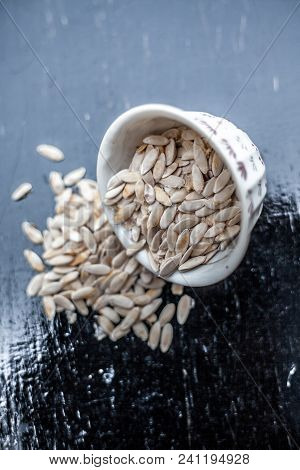 Edible Dried Raw Organic Seeds Of Musk Melon Or Cantaloupe Or Tati Or Honeydew On A Wooden Surface.