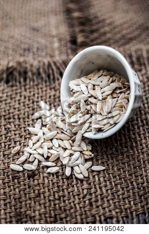 Edible Dried Raw Organic Seeds Of Musk Melon Or Cantaloupe Or Tati Or Honeydew On A Wooden Surface.