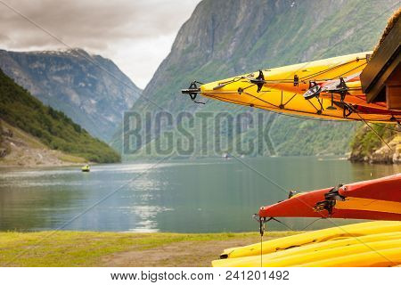 Active Lifestyle Sport Concept. Many Canoes Outdoor In Rental Center, Norwegian Fjord Landscape In T