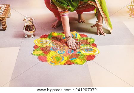 Women Coloring Tradition Colorful Rice Art Or Sand Art (rangoli) On The Floor With Paper Pattern Usi