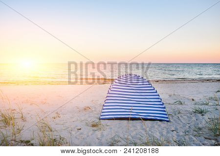 Tents On Beach Of White Sandunder Blue Sky