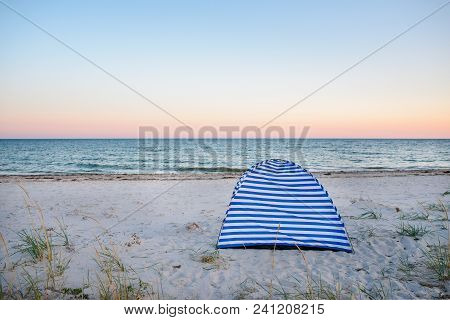 Tents On Beach Of White Sandunder Blue Sky