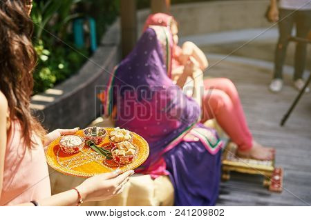 The Indian Women Holding The Yellow Tray Of Prayer Items During Thread Ceremony (puja, Pooja) Of Ind