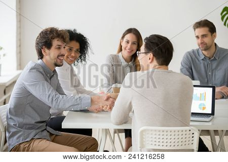 Two Smiling Businessmen Or Project Team Members Shaking Hands At Multiracial Group Meeting, New Male