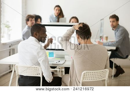 Rear View Of Stressed Businessman Suddenly Realized Problem Mistake Using Pc With Colleague In Offic