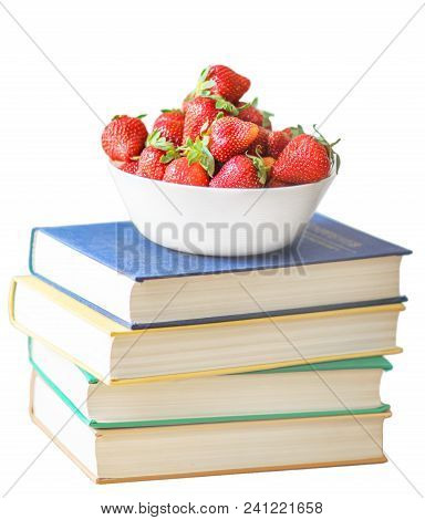 Fresh Summer Red Strawberries In A White Cap On Pile Or Stack Of Books Or Classbooks Isolated On Whi