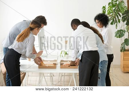 Rear View At Corporate Employees Team Sharing Pizza In Office, Multiracial Colleagues Eating Italian