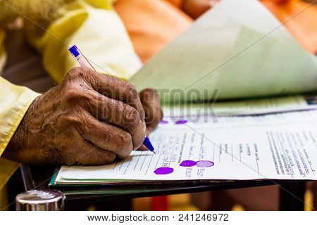 Hand Of An Old Man Writing Important Legal Document