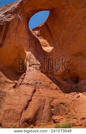 Eye Of The Eagle Big Hogan. Pothole Natural Arch Eroded In Sandstone. Navajo Tribal Park Of Monument