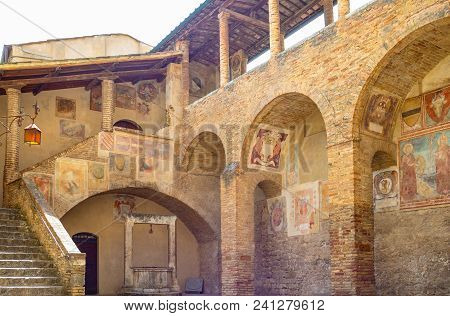 San Giminiano, Italy - May 26, 2016: The Decorations And Frescoes Of The Town Hall Courtyard