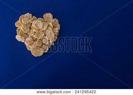 Corn Flakes In The Form Of Heart On A Blue Background