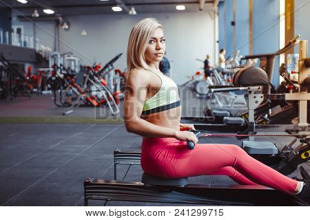 Beautiful Woman Is Doing Exercises In The Sport Club.