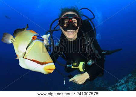 Scuba diving in ocean with fish