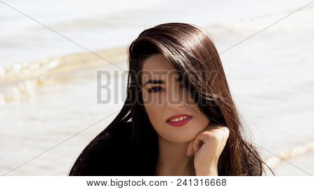 Happy Woman On The Beach. Portrait Of A Beautiful Girl Close-up. Spring Portrait On The Beach. Young