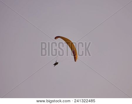 Paraglider Silhouette Flying Over Misty Mountain Valley In Beautiful Warm Sunset Colors - Sport, Act