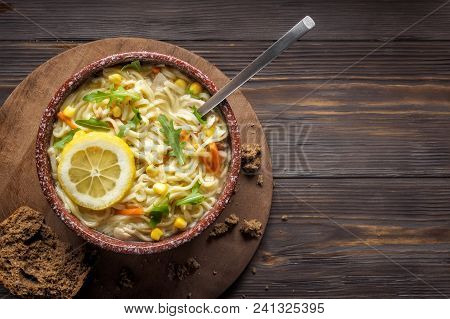 Asian Food Chinese Soup With Noodles In Bowl Vegetables Onion Carrots Greens Leaves Arugula Corn And