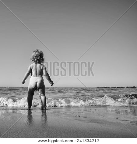 Happy Kid Having Fun. Childhood. Baby Boy One Cute Fair-haired Blond Kid Tiny Little Child Back View