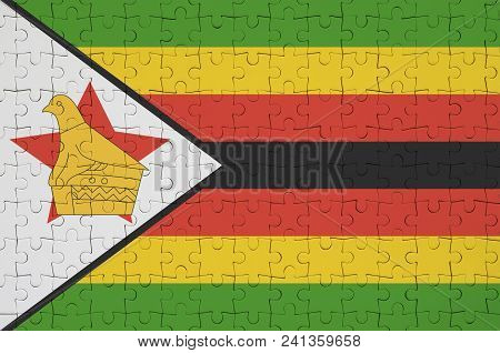Zimbabwe Flag  Is Depicted On A Folded Puzzle