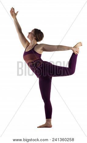 Beautiful Young Woman Working Out In Studio, Doing Yoga Exercise On Floor, Stretching, Standing In D