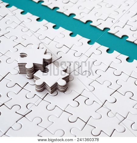 The Blue Path Is Laid On The Platform Of A White Folded Jigsaw Puzzle. The Missing Elements Of The P