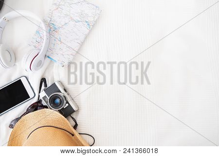 Top View Of Accessories Travel (camera,hat,headphone,map ) On Bed Blankket.prepareing For Holiday Va