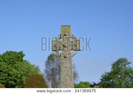 Celtic Cross In Colour Ina Graveyard In Sunlight