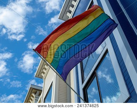 Upward View Of Gay Pride, Lgbt Flag Handing Outside Of A House