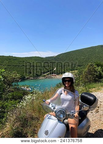 Girl On Scooter Near Ploce Beach; Montenegro.