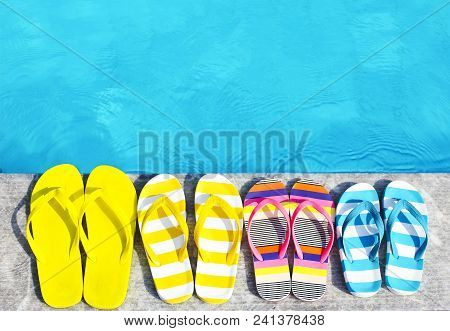 Flip Flops On Stone Background On Poolside. Summer Family Vacation Concept