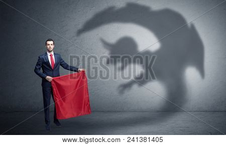 Businessman standing with red cloth in his hand and imp shadow on the background