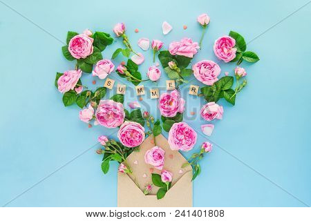Close Up Creative Layout With Pink Tea Rose Flowers, Leaves Fly Out Of Croped Craft Paper Envelope I