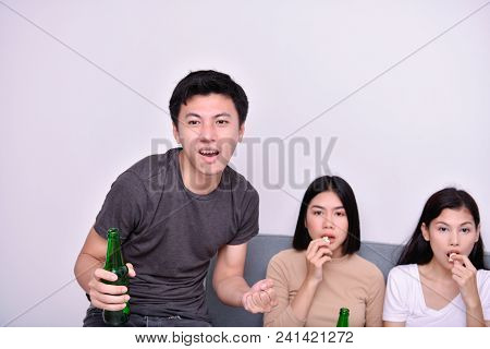 Concept Of Cheering. Asian Teenagers Watching Football On Television. People Are Cheering And Winnin