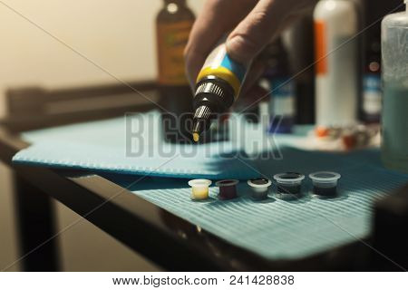 Tattoo Ink Poured Into Small Caps In Studio. Equipment For Making Tattoo