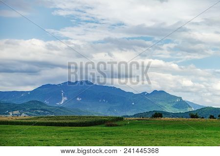 A Typical Natural Landscape In The Country Of Suceava: Green Fields And Mountains On The Horizon, Ro
