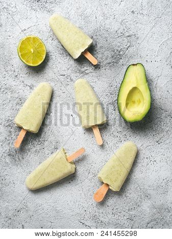 Homemade Raw Vegan Avocado Lime Popsicle. Sugar-free, Non-dairy Green Ice Cream On Gray Background. 