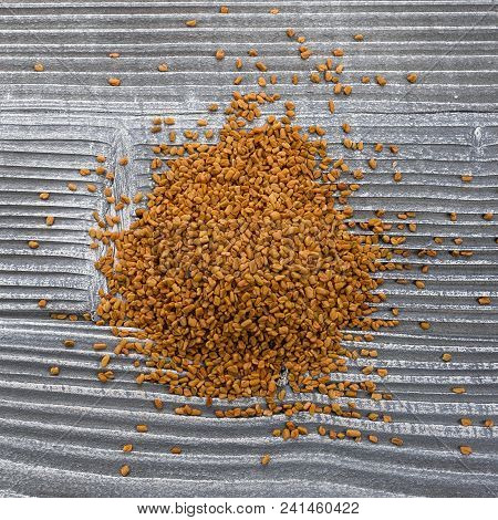 Fragrant Grains Of Fenugreek On A Rustic Background.