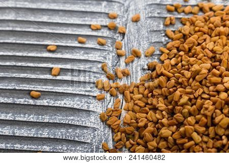 Fragrant Grains Of Fenugreek On A Rustic Background.