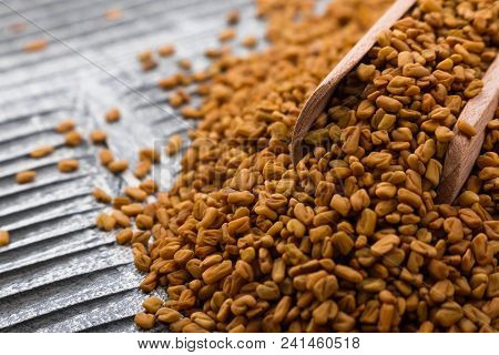Fragrant Grains Of Fenugreek On A Rustic Background.