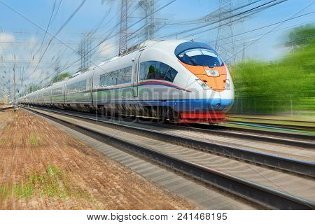 Moscow, May, 18, 2018: Diagonal View On High Speed Train Runs On Rail Way Tracks And Trees In The Ba