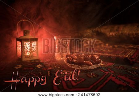 Water And Dates. Iftar Is The Evening Meal. View Of Decoration Ramadan Kareem Holiday On Carpet. Fes
