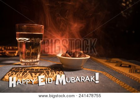 Water And Dates. Iftar Is The Evening Meal. View Of Decoration Ramadan Kareem Holiday On Carpet. Fes